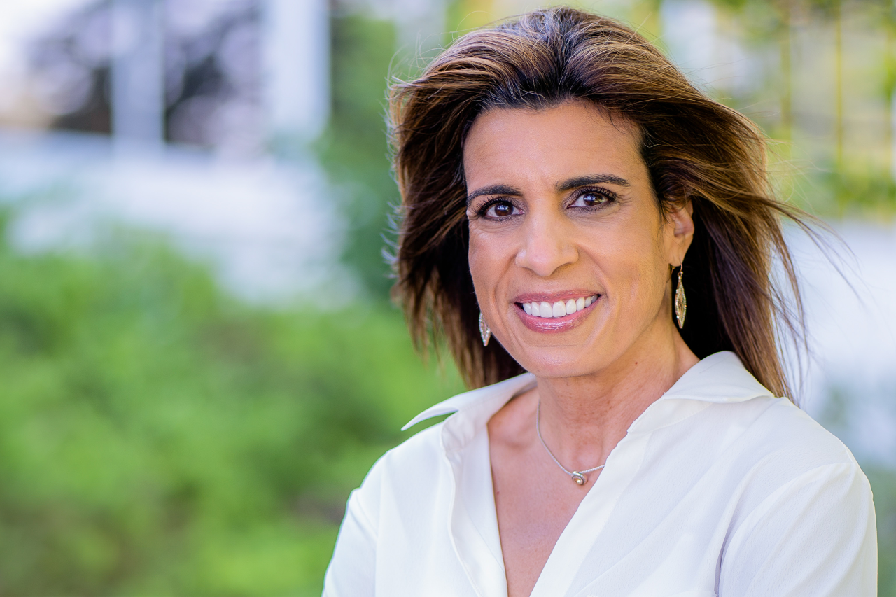 White woman smiling at camera outside