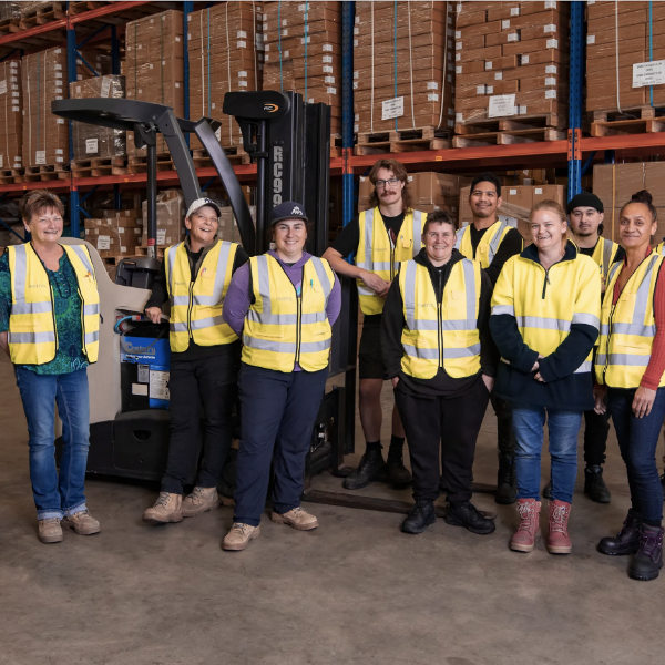 group of employees smiling in factory