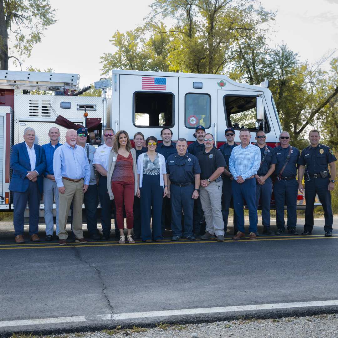 IDEAL leadership smiling with Sycamore firefighters in front of fire truck
